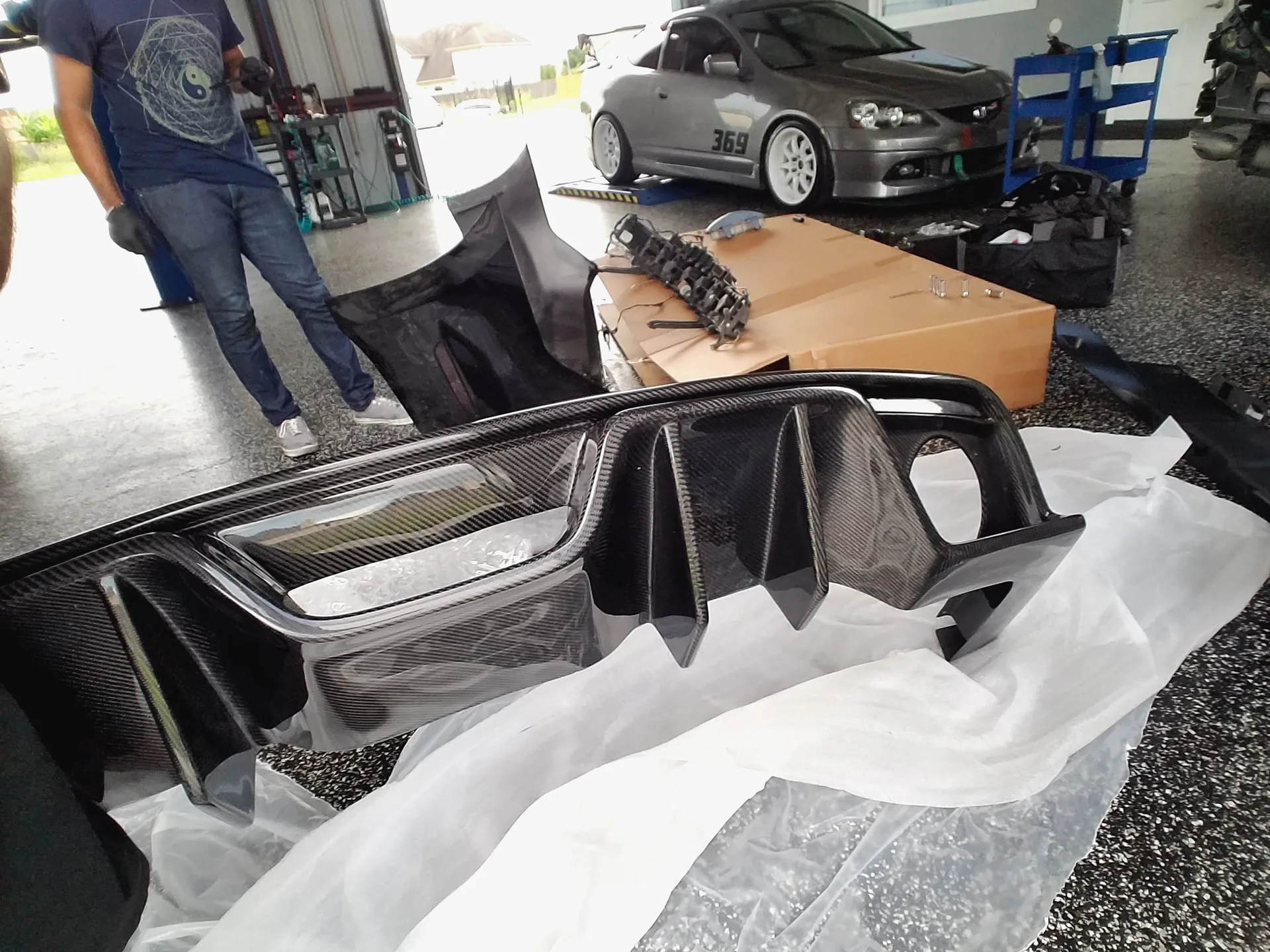 Carbon fiber rear diffuser being prepared for installation