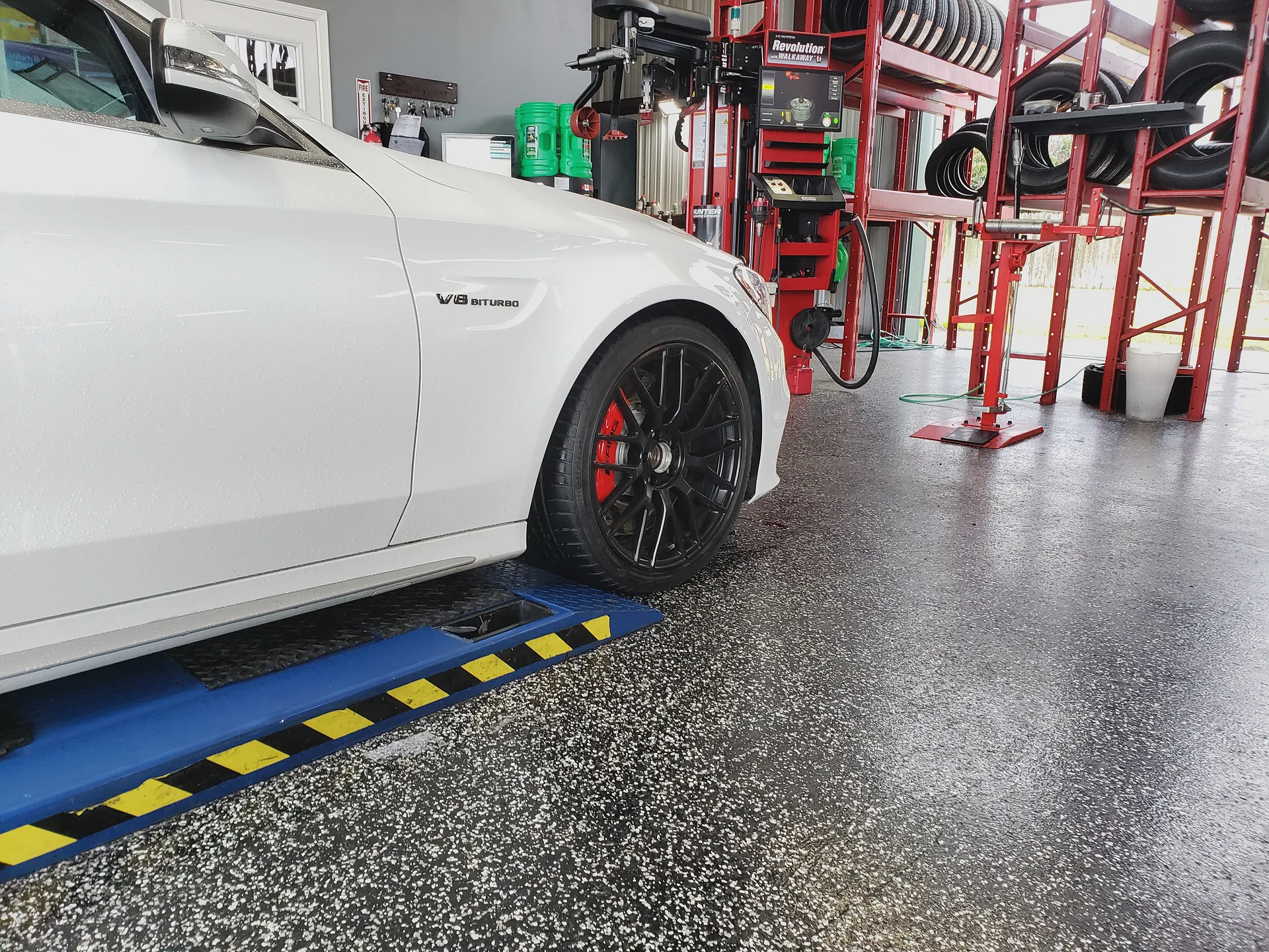 White Mercedes-Benz CLS63 AMG on the lift for brake and caliper service