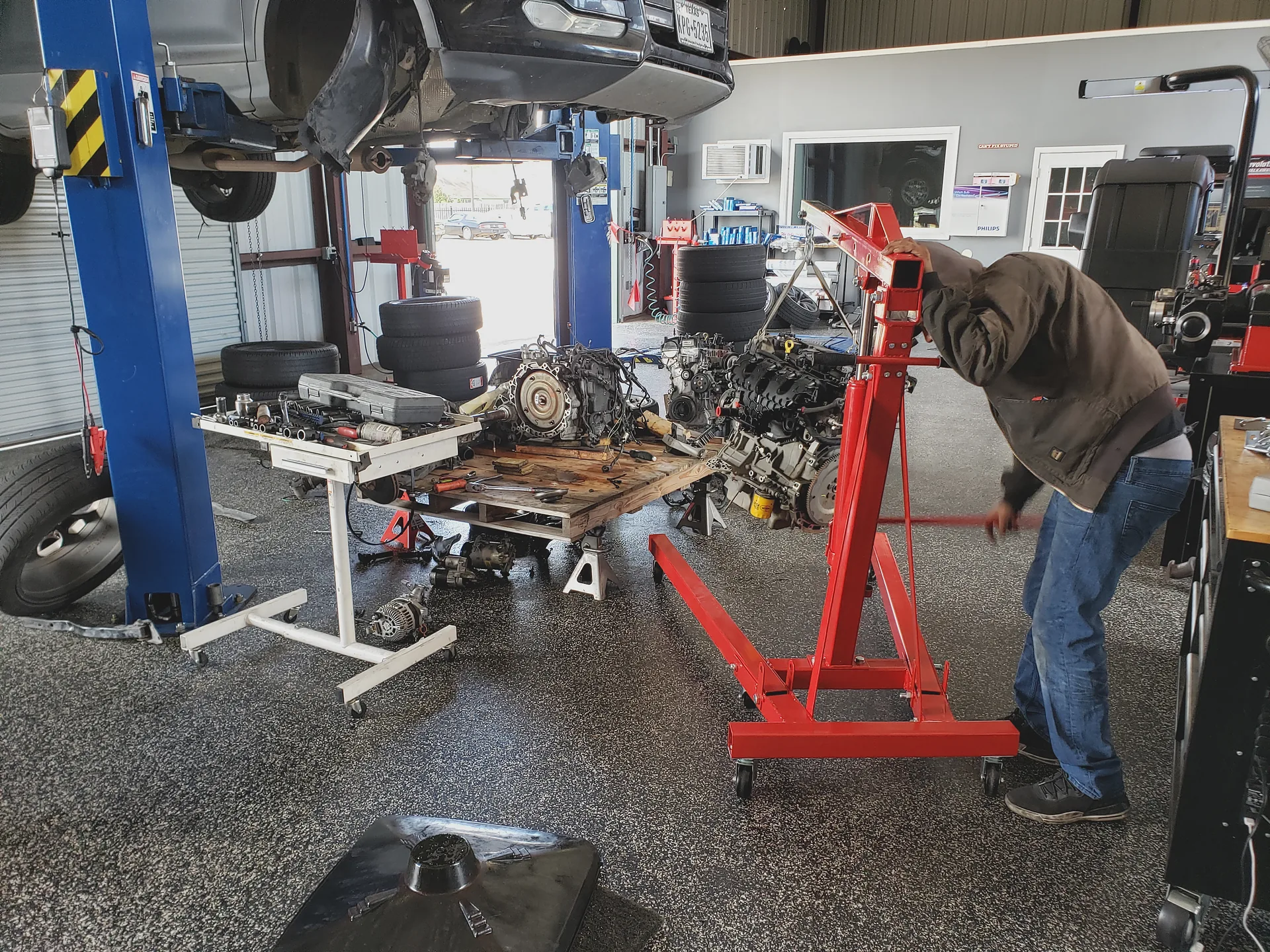 Engine removal in progress on the service lift
